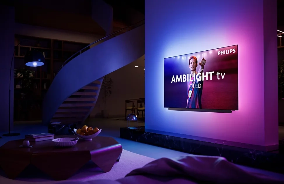 Ein moderner Philips Ambilight OLED Fernseher in einem stilvollen Wohnzimmer.