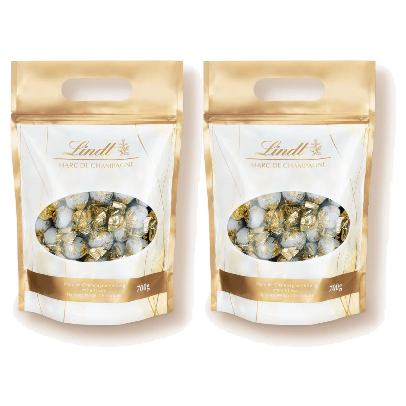 Zwei goldene Lindt Päckchen gefüllt mit Marc de Champagne Pralinen