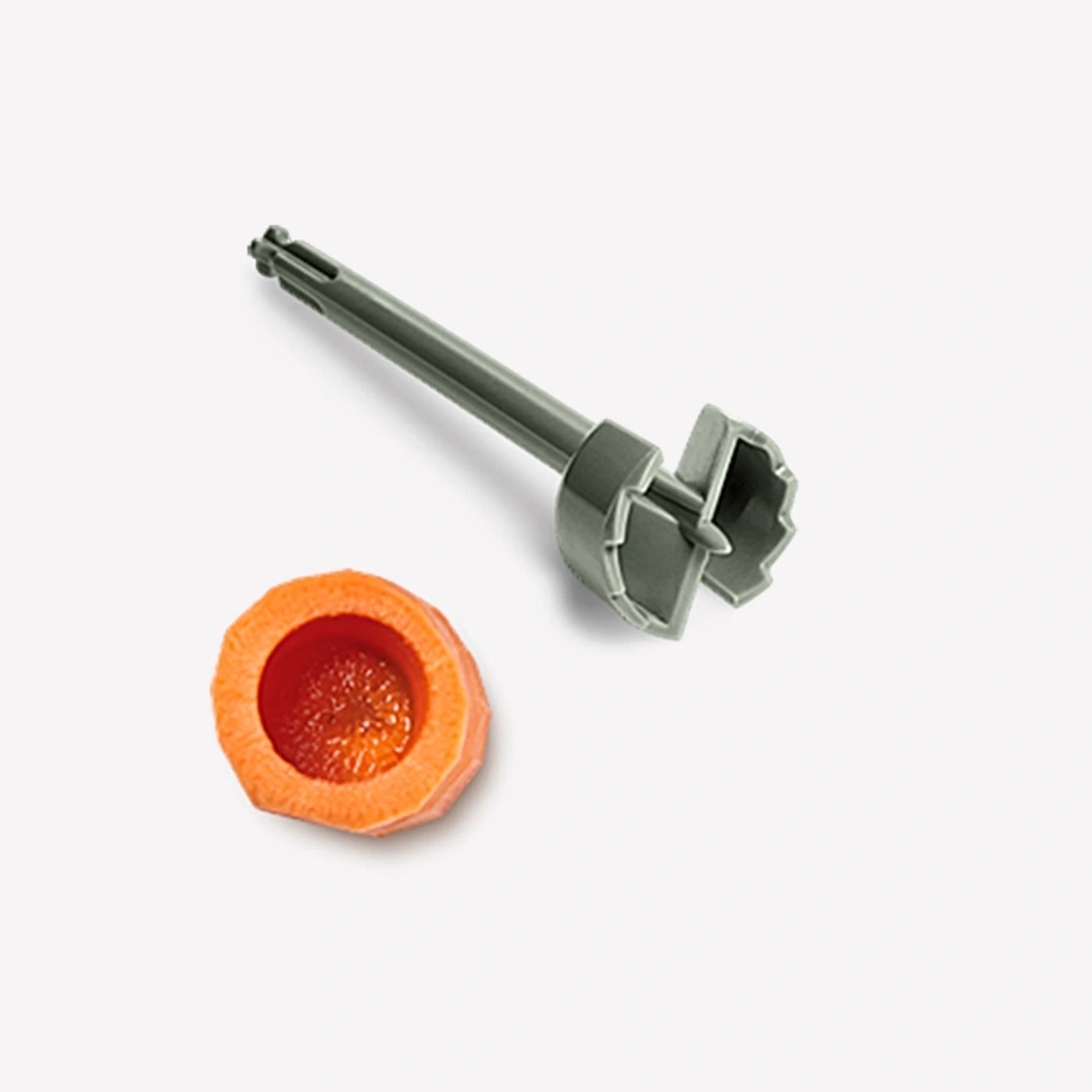 Gemüseschneider und Karotte auf weißem Hintergrund. Küchenutensil zum Aushöhlen.