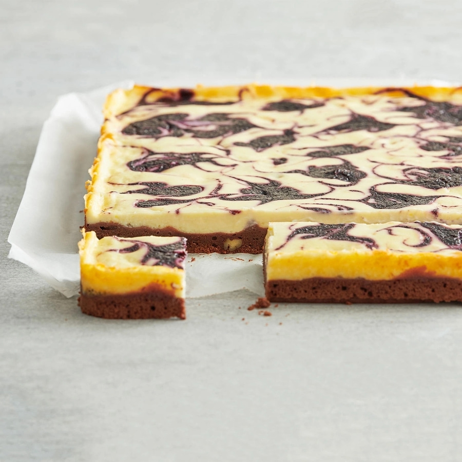 Kuchen mit Blaubeeren, auf Backpapier, angeschnitten, Nahaufnahme, lecker