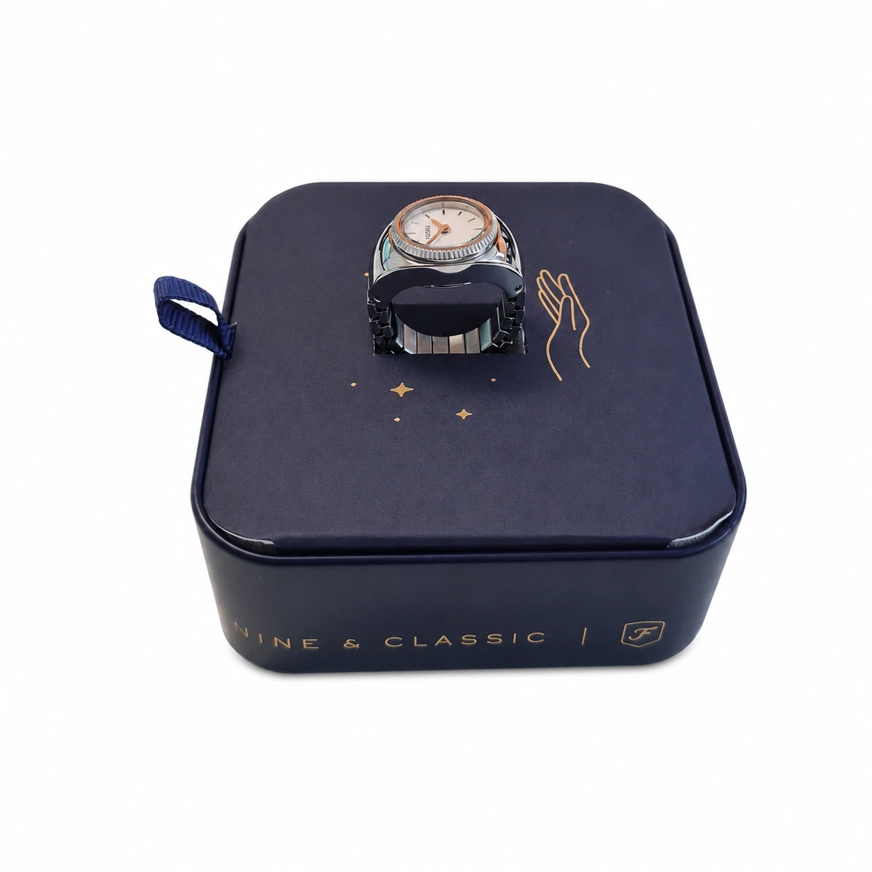Eine Uhr in Ringform auf einer dunkelblauen Geschenkbox mit Sternenmuster und einer Handzeichnung.
