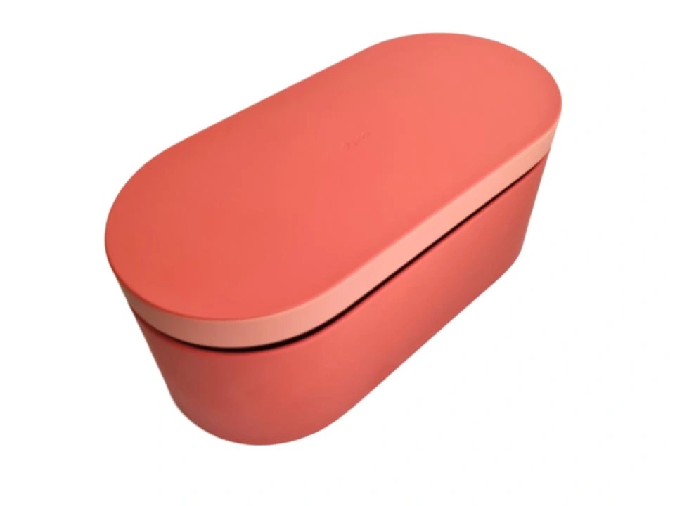 Eine rechteckige Aufbewahrungsbox mit abgerundeten Ecken in Korallenrot und Rosa.