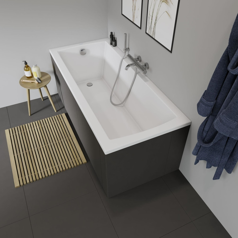 Badezimmer mit Badewanne, Badematte, Handtuch und Dekoration. Graue Fliesen.
