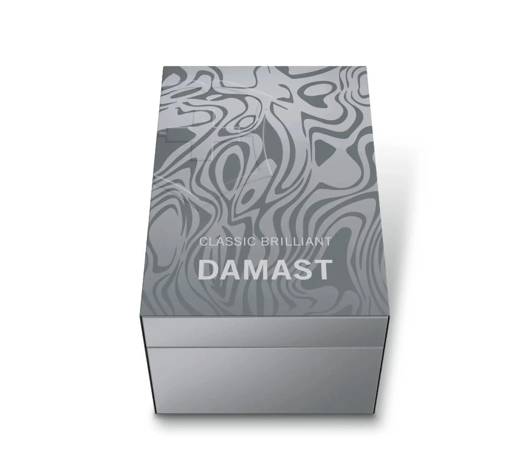 Graue Schachtel mit Damast-Muster und Aufschrift 'DAMAST' und 'CLASSIC BRILLIANT'