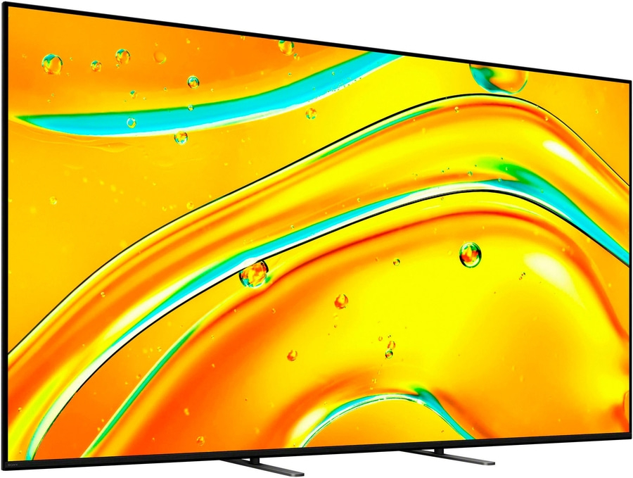 Ein moderner Fernseher mit einem abstrakten, gelb-orangenen Hintergrund mit Blasen.