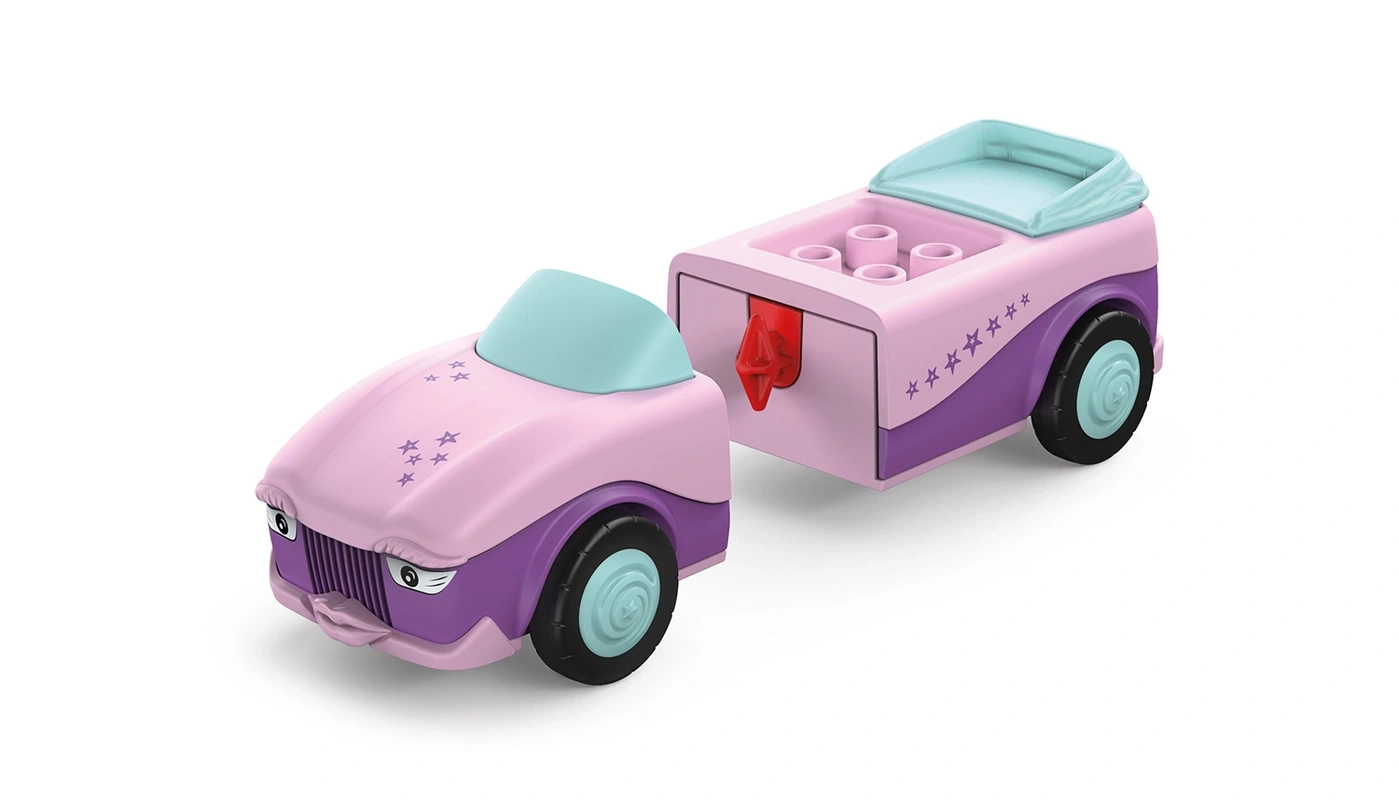 Ein rosa und violetter Spielzeugwagen mit Anhänger und Sternenmuster.