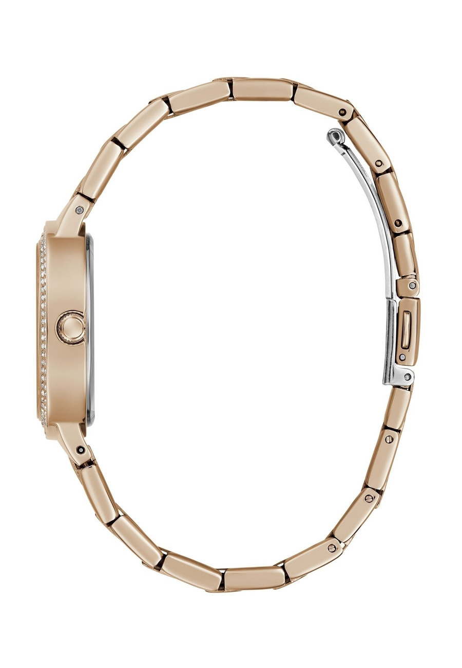 Ein roségoldenes Armband einer Damenuhr mit funkelnden Steinen.