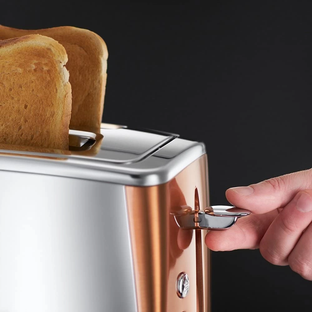 Nahaufnahme eines Toasters mit Toastbrot und einer Hand, die den Hebel betätigt
