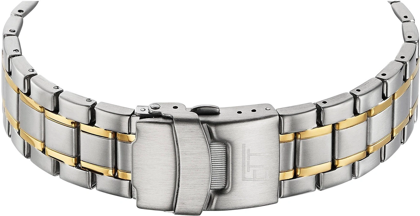 Nahaufnahme eines silbernen und goldenen Armbands mit Verschluss und Logo