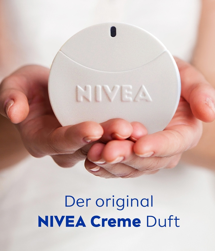 Hände halten Nivea Creme Duft. Weißes Produkt mit Nivea-Logo. Text: Der original NIVEA Creme Duft.