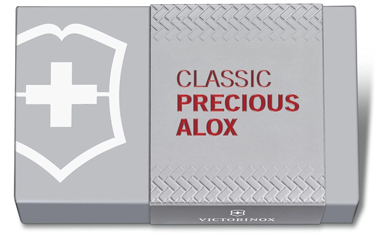 Graue Schachtel mit rotem Text und weißem Logo, 'CLASSIC PRECIOUS ALOX' und 'VICTORINOX'.