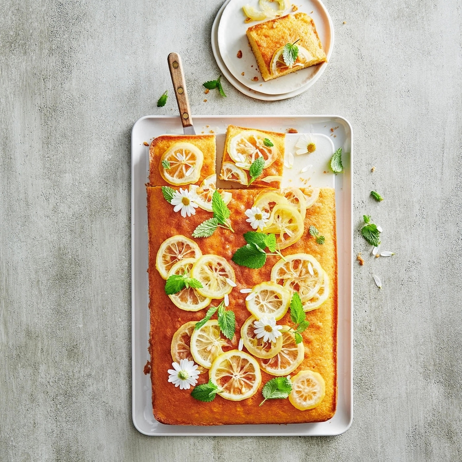 Zitronenkuchen mit Dekoration, auf einem Tablett und Teller