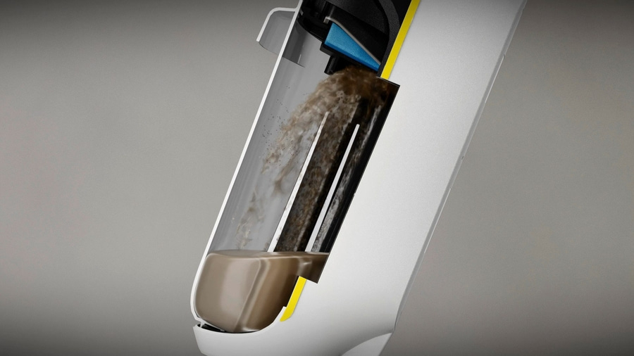 Schnitt durch einen Staubsauger, der Schmutz und Staub zeigt, der in einen Behälter gelangt.