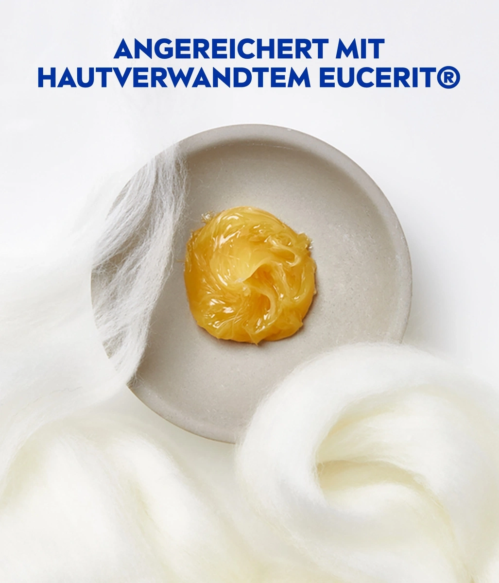 Creme auf einem Teller, umgeben von weißer Wolle, mit Text