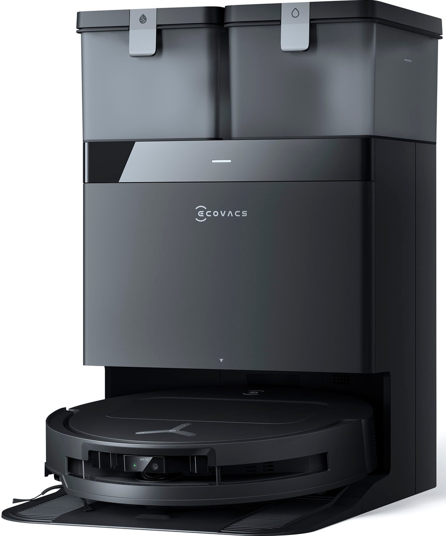 Ein schwarzer Saugroboter mit Ladestation und zwei Behältern.