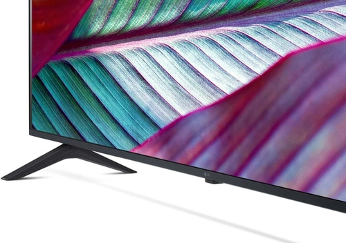 LG Fernseher mit bunten Blättern auf dem Bildschirm und schwarzem Ständer.