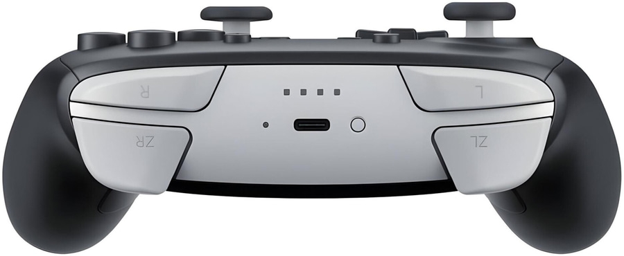 Ein schwarzer und weißer Controller mit Knöpfen und Joysticks.