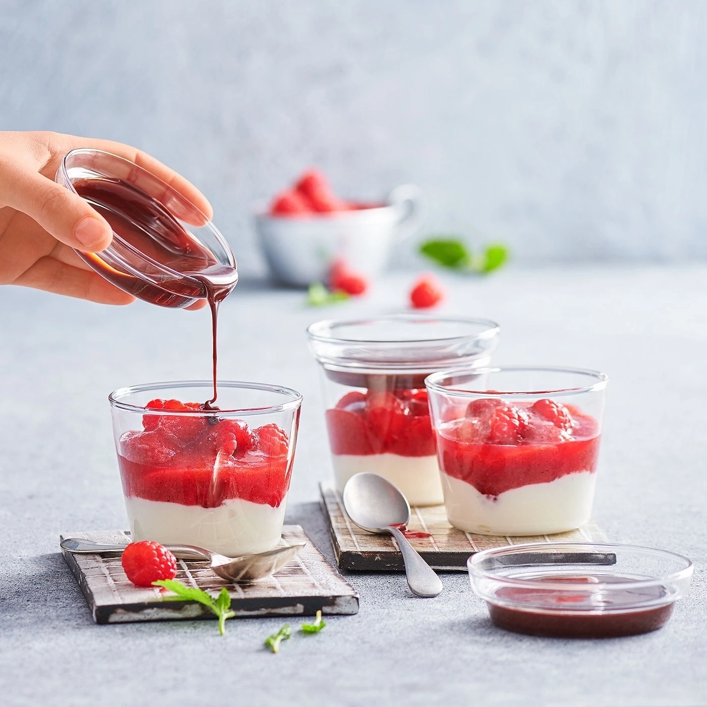 Dessert mit Himbeeren und Schokoladensauce, in Gläsern serviert, Nahaufnahme
