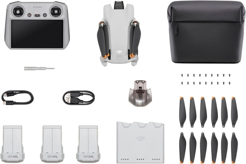 Drohne mit Zubehör: Fernbedienung, Akkus, Propeller, Ladegerät, Tragetasche, Schraubendreher.