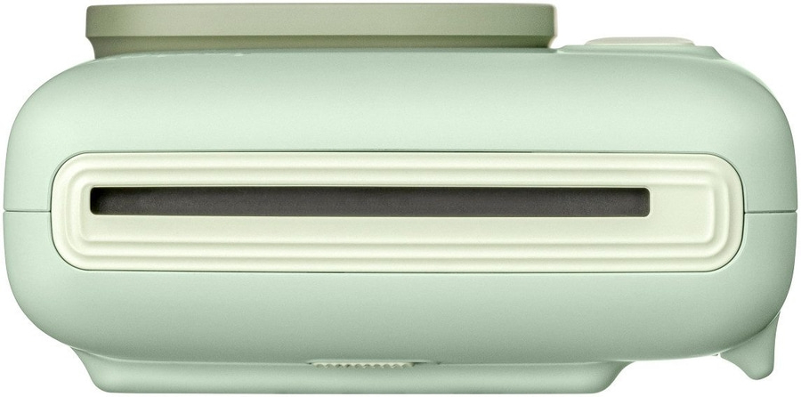 Hellgrüner Sofortbilddrucker mit cremefarbenem Rahmen und dunklem Schlitz für Fotos.