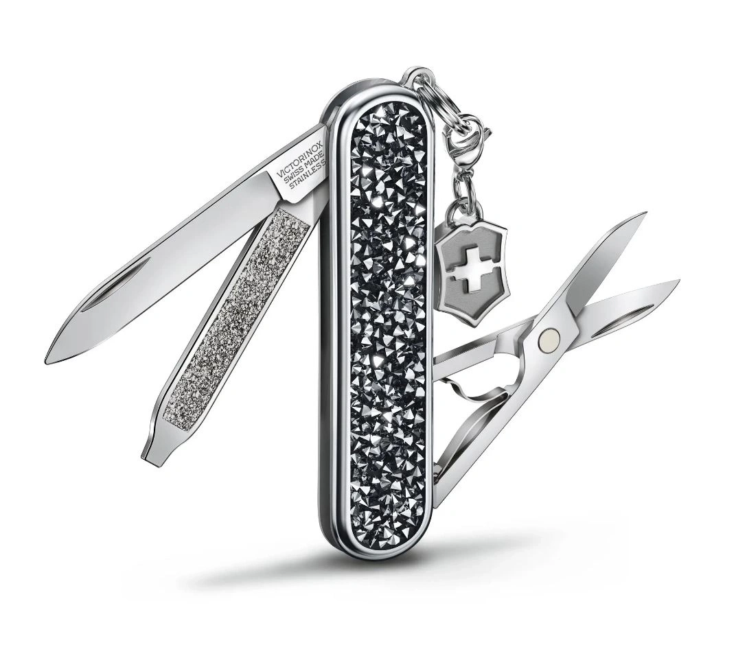 Schweizer Taschenmesser mit Kristallen, Schere und Anhänger mit Kreuz.