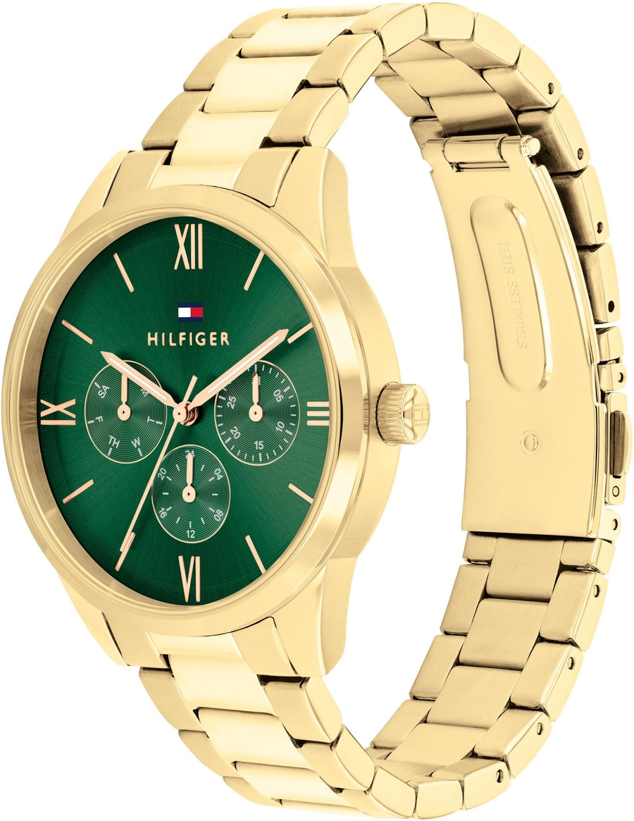 Eine goldene Tommy Hilfiger Damenuhr mit grünem Zifferblatt und einem Edelstahlarmband.