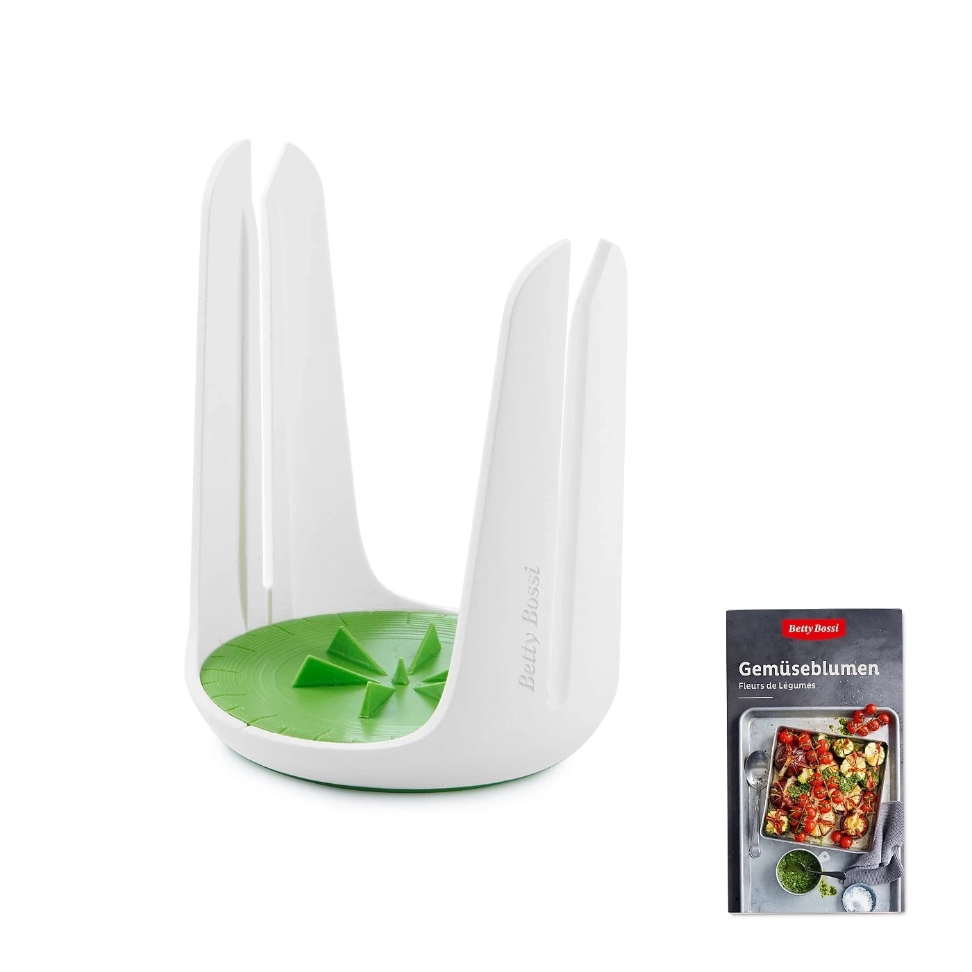 Weißes Küchenutensil mit grünem Einsatz und Kochbuch mit Gemüse