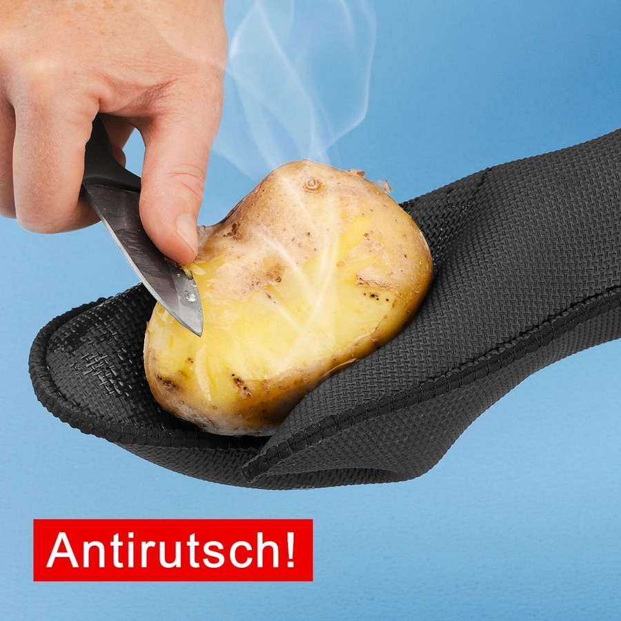 Eine Hand schneidet eine Kartoffel mit einem Messer, die in einem schwarzen Handschuh liegt.