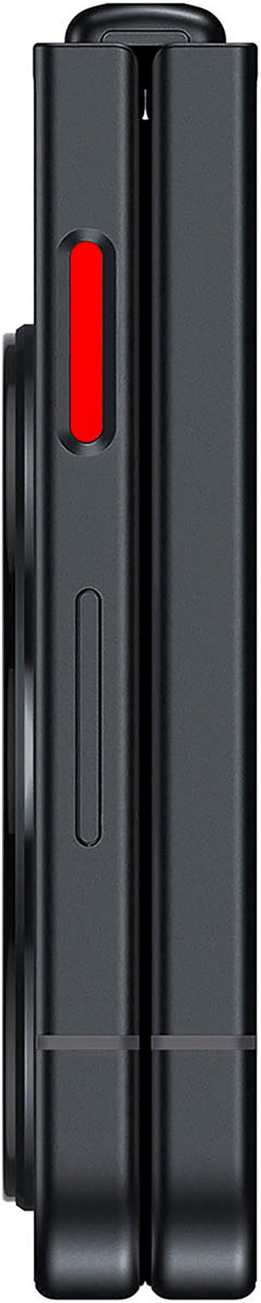 Schwarzes Gerät mit rotem Knopf und länglichem Design, das an ein Smartphone erinnert.