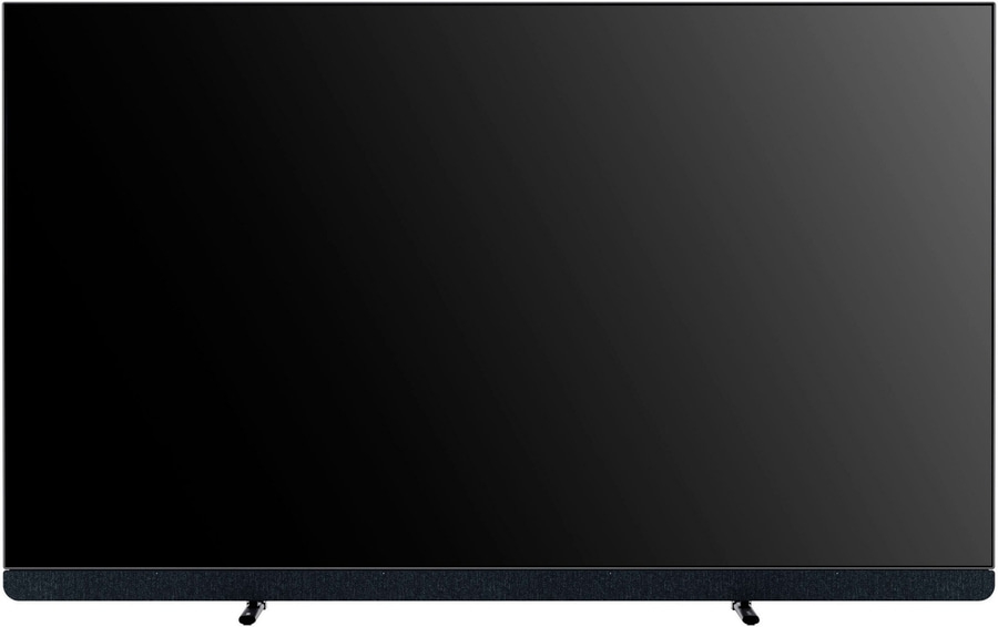 Großer schwarzer Fernseher mit Soundbar und zwei Füßen, die nach unten zeigen.