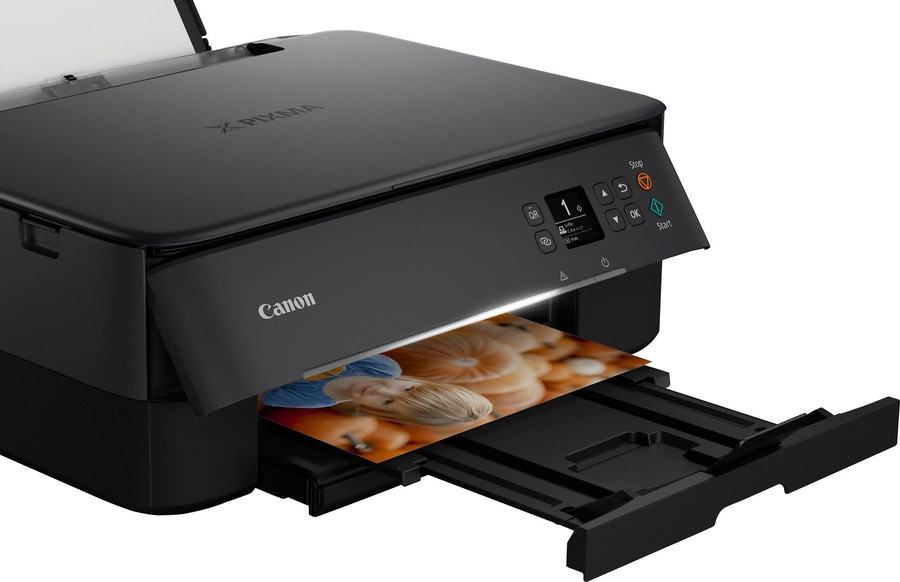 Schwarzer Canon Pixma Drucker, der ein Foto ausdruckt, mit Bedienfeld und Starttaste.