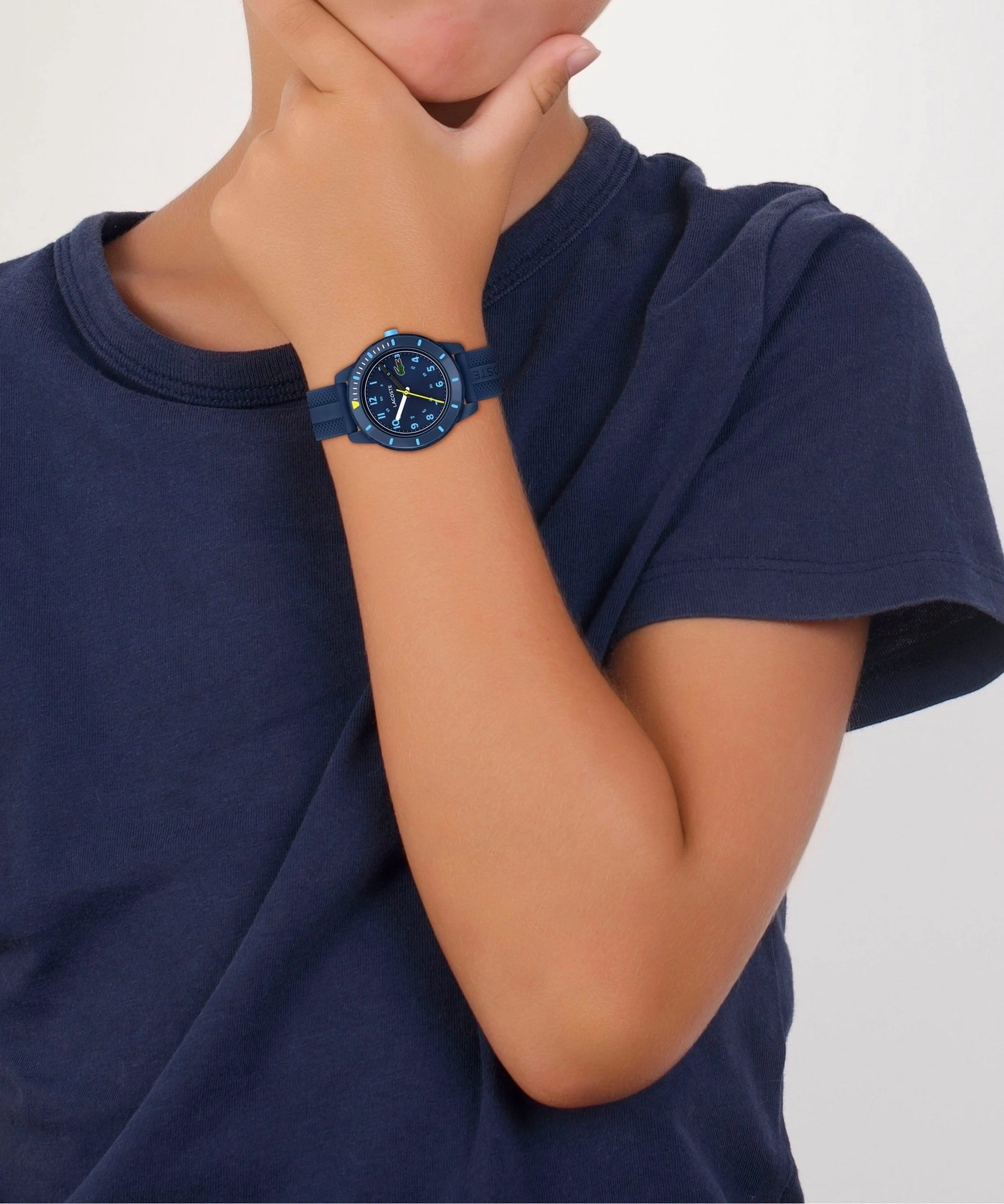 Kind trägt eine blaue Uhr am Handgelenk.