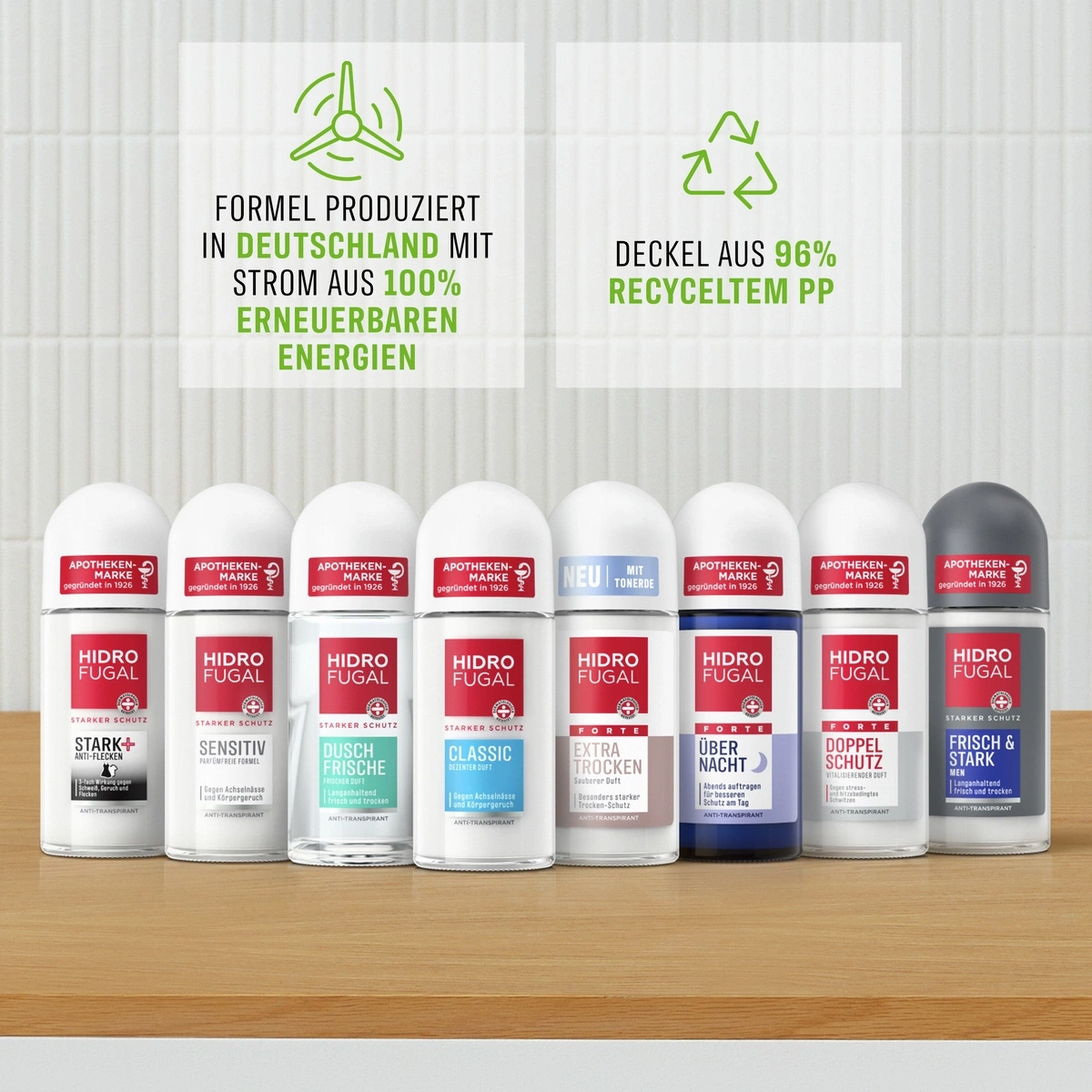Mehrere Hidro Fugal Deodorants auf einem Holztisch vor einem Hintergrund mit Öko-Informationen.