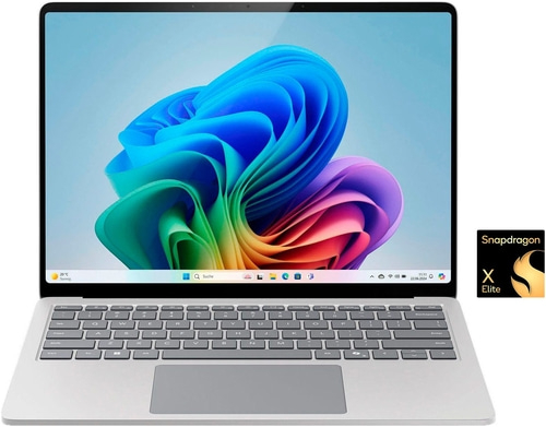 Laptop mit Snapdragon X Elite Prozessor, Windows-Oberfläche, Tastatur und Bildschirm mit bunten Farben.