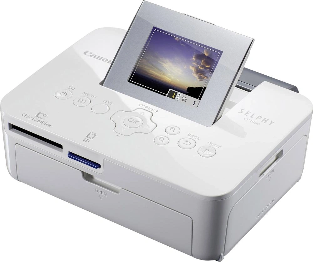Ein weißer Canon Selphy CP1000 Fotodrucker mit SD-Kartensteckplatz und LCD-Bildschirm.
