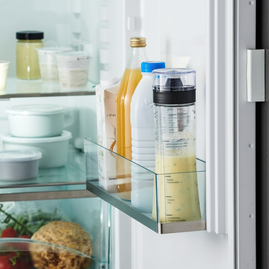 Kühlschrank mit Dressing, Saft und Milch. Gemüse und Obst im Kühlschrank.