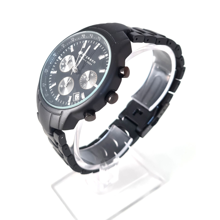 Schwarze Armbanduhr mit drei Zifferblättern und Tachymeter auf dem Rand, auf einem transparenten Ständer.