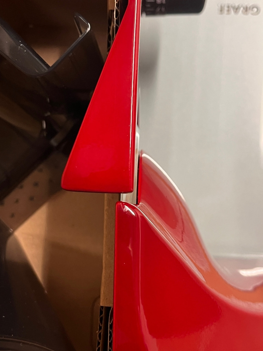 Rotes Objekt, das in einer Pappschachtel platziert ist, Nahaufnahme.