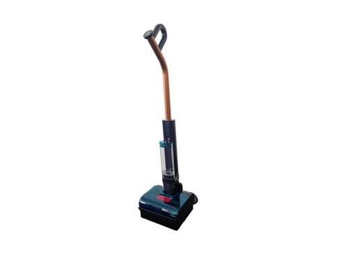 ein Dyson kabelloser Nass-/Trockensauger mit einem transparenten Behälter und einem Kupferrohr, der auf dem Boden steht.