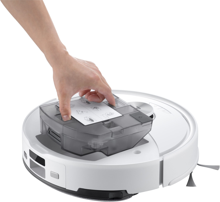 Ein Roboterstaubsauger mit abnehmbarem Staubbehälter und Bedienungsanleitung.