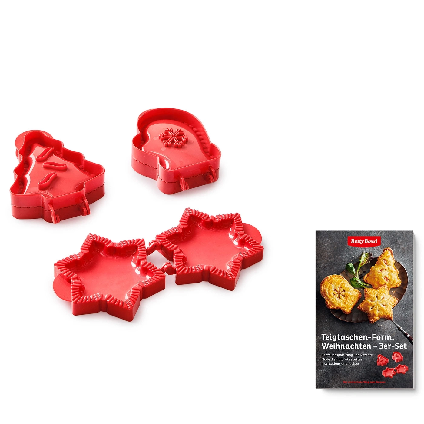 Drei rote Ausstecher in Weihnachtsformen: Tannenbaum, Stern und Handschuh, mit einem Rezeptbuch